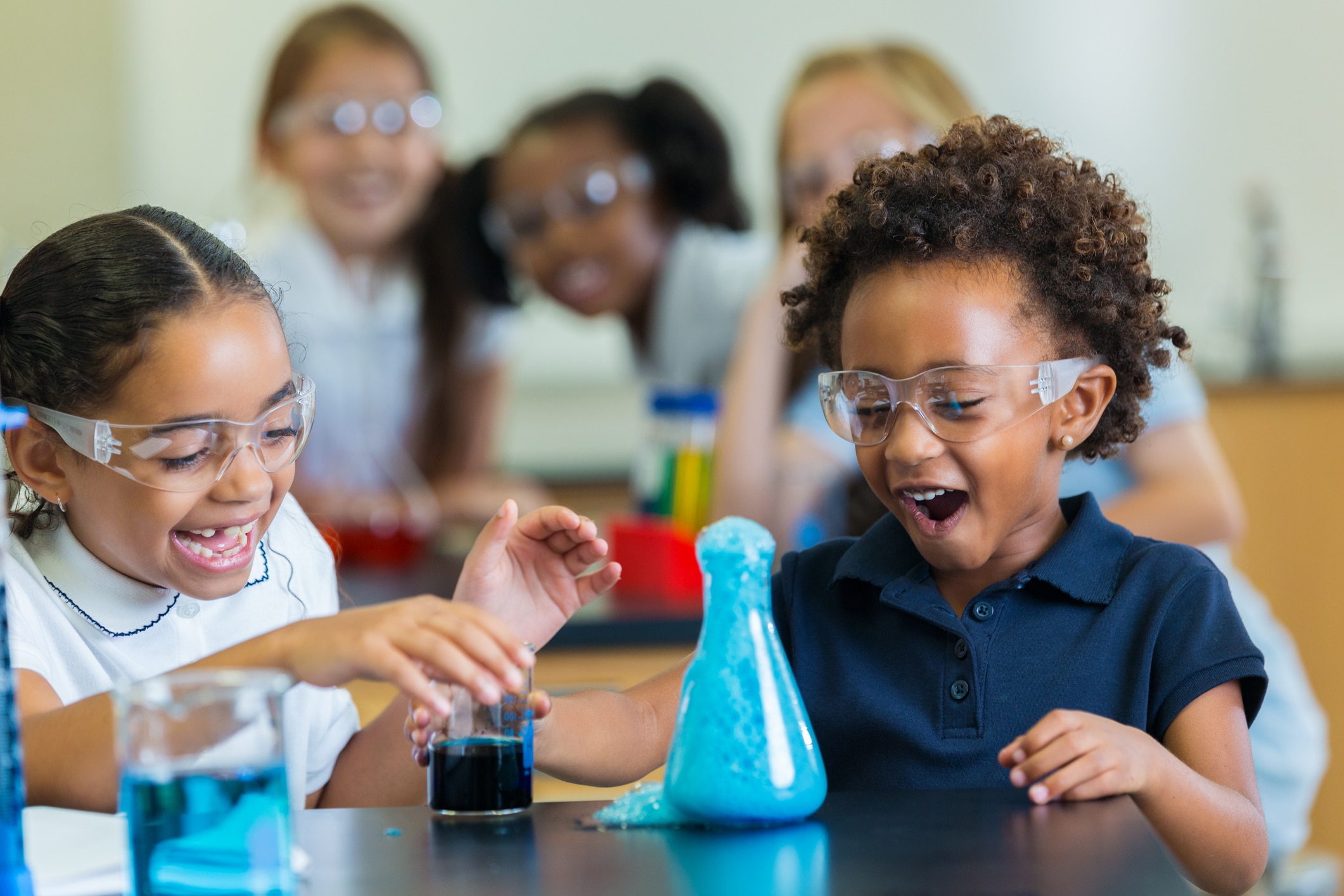 Excited-school-girls-during-chemistry-experiment-639407632_2125x1416